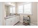 Bright bathroom features a white vanity, gray countertop, and a large mirror for a clean and modern look at 257 Auburn View Rd, Rock Hill, SC 29730