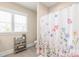 Well-lit bathroom with floral shower curtain, neutral walls, and a small shelf for added storage and decor at 257 Auburn View Rd, Rock Hill, SC 29730