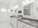 Contemporary bathroom with double vanity, gray countertop, wall-mounted mirrors, and bright lighting at 257 Auburn View Rd, Rock Hill, SC 29730