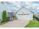 Detached garage with a white door and adjacent backyard space providing parking and outdoor recreational opportunities at 257 Auburn View Rd, Rock Hill, SC 29730