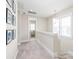 Bright hallway with neutral decor, carpet flooring, and access to a bathroom, enhanced by natural light from a nearby window at 257 Auburn View Rd, Rock Hill, SC 29730