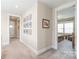 Neutral hallway featuring carpet flooring, crisp white trim, and a series of framed art pieces enhancing the overall aesthetic at 257 Auburn View Rd, Rock Hill, SC 29730