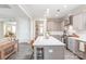 Well-lit open concept kitchen with an island with seating and modern appliances and finishes, and grey cabinets at 257 Auburn View Rd, Rock Hill, SC 29730