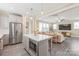 Open concept kitchen with stainless steel refrigerator and microwave with eat-in island connecting to the living room at 257 Auburn View Rd, Rock Hill, SC 29730