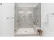 Modern bathroom shower with a seamless glass enclosure, tiled walls, built in shelves, and dual shower heads at 257 Auburn View Rd, Rock Hill, SC 29730