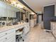 Bathroom vanity and sink with large mirror and drawers and cabinets, chair and tiled floor at 2915 Old Stage Rd, Gastonia, NC 28052