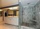 Marble-tiled glass-enclosed shower and double vanity with gray walls in bathroom at 2915 Old Stage Rd, Gastonia, NC 28052
