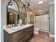 Updated bathroom with double sink vanity, dark wood cabinets, and glass-enclosed shower at 2915 Old Stage Rd, Gastonia, NC 28052