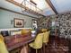 Elegant dining room boasts a rustic wood table, stone accent wall and contemporary lighting fixture at 2915 Old Stage Rd, Gastonia, NC 28052