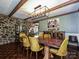 The dining room features a rustic wood table, stone accent wall, and modern chandelier at 2915 Old Stage Rd, Gastonia, NC 28052