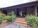 Charming front porch with brick steps and lush greenery surrounding the entrance at 2915 Old Stage Rd, Gastonia, NC 28052