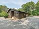 A large garage attached to the home, with an extensive driveway and surrounded by mature trees and landscaping at 2915 Old Stage Rd, Gastonia, NC 28052