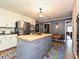 Kitchen features stainless appliances, a butcher block island, and bright custom floor covering at 2915 Old Stage Rd, Gastonia, NC 28052