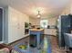 Well-lit kitchen features stainless appliances, a butcher block island, and bright custom floor covering at 2915 Old Stage Rd, Gastonia, NC 28052