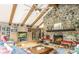 Stone fireplace and a vaulted ceiling with exposed beams, creating a cozy, rustic atmosphere at 2915 Old Stage Rd, Gastonia, NC 28052