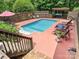 Backyard swimming pool with a lounge area, wooden fence, and a shaded pergola at 2915 Old Stage Rd, Gastonia, NC 28052