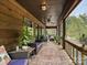 Relaxing screened porch featuring comfortable seating, natural wood finishes, and serene wooded views at 2915 Old Stage Rd, Gastonia, NC 28052
