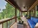 Relaxing screened porch with wooden floors and comfortable outdoor seating, offering peaceful green views at 2915 Old Stage Rd, Gastonia, NC 28052