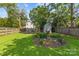 Lush backyard with a garden bed, wooden fence, and shed at 3035 Florida Ave, Charlotte, NC 28205