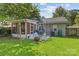 Backyard with a patio area, screened-in porch, and well-maintained lawn, perfect for outdoor enjoyment at 3035 Florida Ave, Charlotte, NC 28205