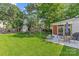 Spacious backyard featuring a lush lawn, shed, patio, and mature trees at 3035 Florida Ave, Charlotte, NC 28205