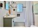 Charming bathroom with white tile, shower, and decorative glass window at 3035 Florida Ave, Charlotte, NC 28205