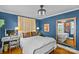Bedroom with desk and vanity, dark blue walls, and wooden floor at 3035 Florida Ave, Charlotte, NC 28205