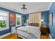Cozy bedroom with dark blue walls, window, closet, and ceiling fan at 3035 Florida Ave, Charlotte, NC 28205