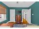 Bedroom with hardwood floors, a dresser, and access to additional rooms at 3035 Florida Ave, Charlotte, NC 28205