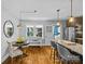 Dining area featuring hardwood floors, a table set, and a view into the kitchen at 3035 Florida Ave, Charlotte, NC 28205