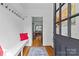 Bright foyer with hardwood floors, coat hooks and a view into the home at 3035 Florida Ave, Charlotte, NC 28205