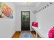 Stylish entryway with hardwood floors, coat rack, and painted front door at 3035 Florida Ave, Charlotte, NC 28205