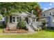 Charming brick home with landscaped front yard, inviting bench, and covered front porch at 3035 Florida Ave, Charlotte, NC 28205