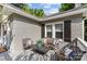 Cozy front porch with seating area, decorative pillows, and brick accents at 3035 Florida Ave, Charlotte, NC 28205