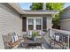 Comfortable front porch with cozy furniture, striped pillows, and brick exterior at 3035 Florida Ave, Charlotte, NC 28205