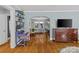 Hallway showcasing hardwood floors, desk with shelving, and view to a dining table set at 3035 Florida Ave, Charlotte, NC 28205