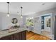 Sunny kitchen adjacent dining area, complete with island seating and hardwood floors at 3035 Florida Ave, Charlotte, NC 28205