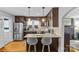 Stylish kitchen featuring dark wood cabinets, granite counters, stainless appliances and breakfast bar at 3035 Florida Ave, Charlotte, NC 28205