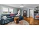 Cozy living room with hardwood floors, a comfortable blue couch, and an eclectic round rug at 3035 Florida Ave, Charlotte, NC 28205