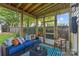 Charming screened porch offering comfortable seating and views of the landscaped yard at 3035 Florida Ave, Charlotte, NC 28205