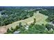 Stunning aerial view highlighting a home's proximity to a lush green golf course and surrounding trees at 3135 Lake Shore S Rd, Denver, NC 28037