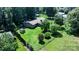 Overhead shot of a home with a spacious backyard, mature trees, shed, and lush green surroundings at 3135 Lake Shore S Rd, Denver, NC 28037