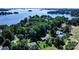 Panoramic aerial view showcasing a lakeside home surrounded by lush greenery and serene blue waters at 3135 Lake Shore S Rd, Denver, NC 28037
