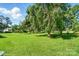 Expansive backyard featuring a lush lawn and mature trees, creating a serene and private outdoor space at 3135 Lake Shore S Rd, Denver, NC 28037