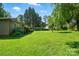 Expansive backyard showcasing lush green grass, mature trees, and a peaceful, secluded setting at 3135 Lake Shore S Rd, Denver, NC 28037
