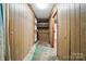 Unfinished basement with wood-paneled walls, offering potential for customization and added living space at 3135 Lake Shore S Rd, Denver, NC 28037
