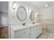 Bathroom features double sinks, white cabinets, and tile flooring at 3135 Lake Shore S Rd, Denver, NC 28037