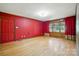Bright bedroom with hardwood floors, red walls, and a large window at 3135 Lake Shore S Rd, Denver, NC 28037