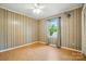 Bedroom boasts wood paneling, laminate floors, and a window with natural light at 3135 Lake Shore S Rd, Denver, NC 28037