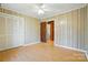 Bedroom featuring wood paneling, laminate floors, and a closet at 3135 Lake Shore S Rd, Denver, NC 28037